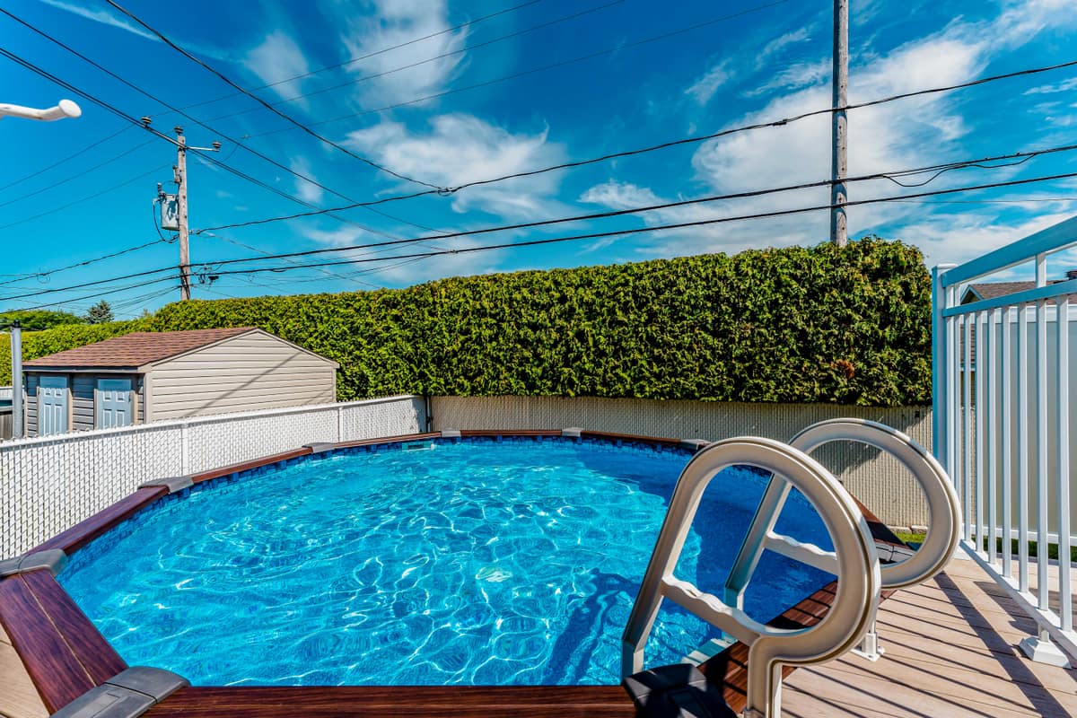 Backyard with pool and staged deck, home staging of a property on the South Shore of Montreal
